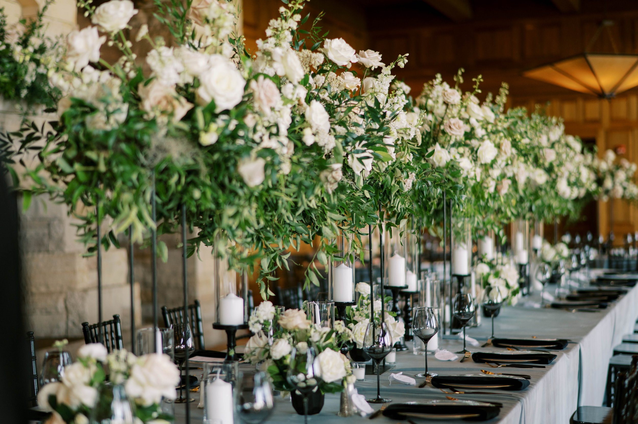 A grand banquet table crowned with lush greenery